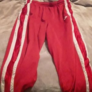 A pair of red& white Nike striped pants,zip ups